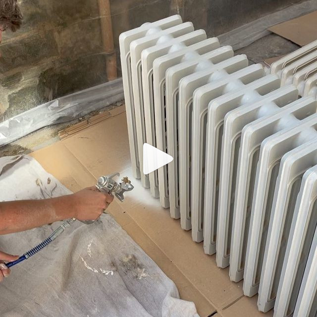 Carefully spraying cast iron radiators.